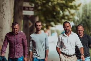 After a productive day at work, a group of diverse colleagues enjoy a leisurely stroll through a modern and natural urban setting photo