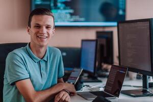 A programmer diligently testing smartphone applications while sitting in their office. photo