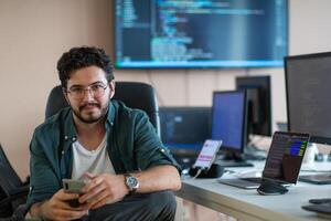 A programmer diligently testing smartphone applications photo