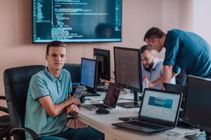 Programmers engrossed in deep collaboration, diligently working together to solve complex problems and develop innovative mobile applications with seamless functionality. photo