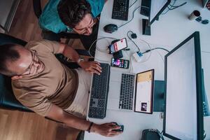 Programmers engrossed in deep collaboration, diligently working together to solve complex problems and develop innovative mobile applications with seamless functionality. photo