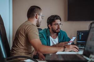 Programmers engrossed in deep collaboration, diligently working together to solve complex problems and develop innovative mobile applications with seamless functionality. photo