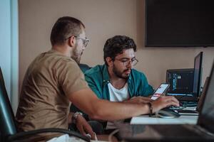 Programmers engrossed in deep collaboration, diligently working together to solve complex problems and develop innovative mobile applications with seamless functionality. photo