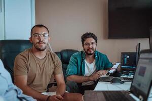 Programmers engrossed in deep collaboration, diligently working together to solve complex problems and develop innovative mobile applications with seamless functionality. photo
