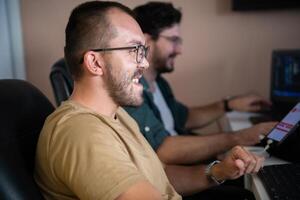 Programmers engrossed in deep collaboration, diligently working together to solve complex problems and develop innovative mobile applications with seamless functionality. photo