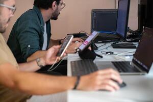 Programmers engrossed in deep collaboration, diligently working together to solve complex problems and develop innovative mobile applications with seamless functionality. photo