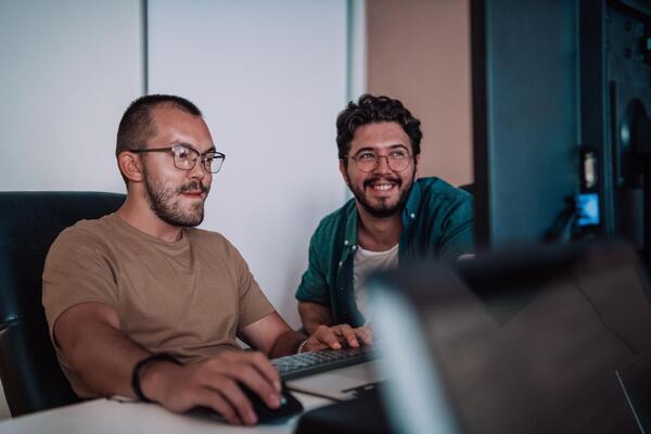 Programmers engrossed in deep collaboration, diligently working together to solve complex problems and develop innovative mobile applications with seamless functionality.