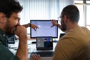 Programmers engrossed in deep collaboration, diligently working together to solve complex problems and develop innovative mobile applications with seamless functionality. photo