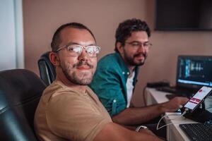 Programmers engrossed in deep collaboration, diligently working together to solve complex problems and develop innovative mobile applications with seamless functionality. photo