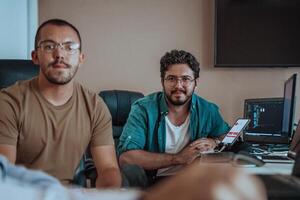 Programmers engrossed in deep collaboration, diligently working together to solve complex problems and develop innovative mobile applications with seamless functionality. photo