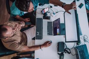 Programmers engrossed in deep collaboration, diligently working together to solve complex problems and develop innovative mobile applications with seamless functionality. photo