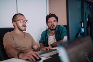 Programmers engrossed in deep collaboration, diligently working together to solve complex problems and develop innovative mobile applications with seamless functionality. photo