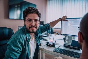Programmers engrossed in deep collaboration, diligently working together to solve complex problems and develop innovative mobile applications with seamless functionality. photo