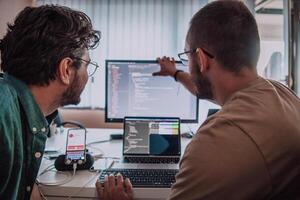 Programmers engrossed in deep collaboration, diligently working together to solve complex problems and develop innovative mobile applications with seamless functionality. photo