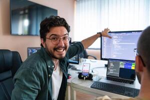 Programmers engrossed in deep collaboration, diligently working together to solve complex problems and develop innovative mobile applications with seamless functionality. photo