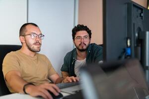 Programmers engrossed in deep collaboration, diligently working together to solve complex problems and develop innovative mobile applications with seamless functionality. photo