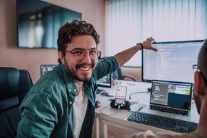 Programmers engrossed in deep collaboration, diligently working together to solve complex problems and develop innovative mobile applications with seamless functionality. photo