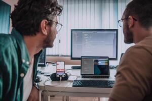 Programmers engrossed in deep collaboration, diligently working together to solve complex problems and develop innovative mobile applications with seamless functionality. photo