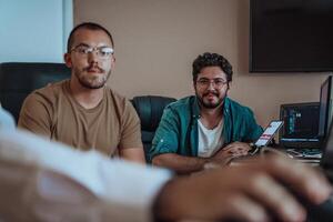 Programmers engrossed in deep collaboration, diligently working together to solve complex problems and develop innovative mobile applications with seamless functionality. photo