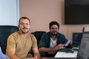 Collaborative Minds. A Team of Programmers Tackling Challenges Together in the Office. photo