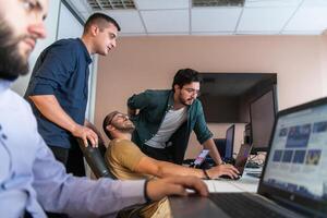 Collaborative Minds. A Team of Programmers Tackling Challenges Together in the Office. photo