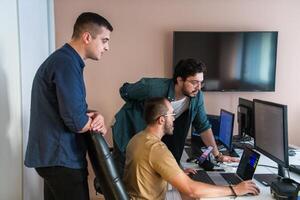 Collaborative Minds. A Team of Programmers Tackling Challenges Together in the Office. photo