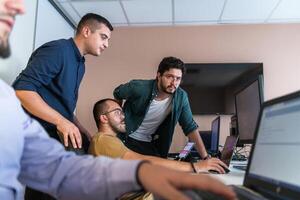 Collaborative Minds. A Team of Programmers Tackling Challenges Together in the Office. photo