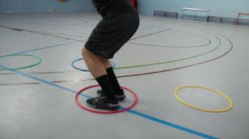 Basket Player Trains With Hoops On Ground Doing Jump On Court video