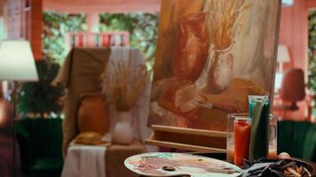 Empty artistic atelier with a rustic watercolor painting displayed on canvas, creative process with acrylic paint in a contemporary art and craft workshop. Masterpiece creation and supplies. video