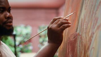 Painter uses a variety of brushes and paint tubes to create masterpiece for the fine art gallery exhibition, creative atelier. Working on colorful artwork with creativity and dedication. Camera A. video