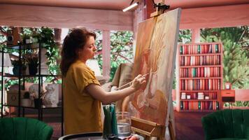 Artist uses talent and tie dye to create a masterpiece on canvas in creative workshop, blending colors with paintbrush. Bringing a rustic artwork to life with a special painting technique. Camera B. video