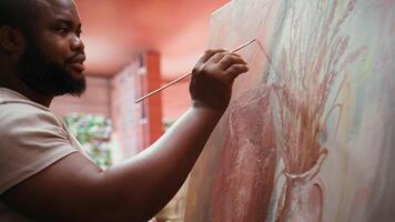 Painter uses a variety of brushes and paint tubes to create masterpiece for the fine art gallery exhibition, creative atelier. Working on colorful artwork with creativity and dedication. Camera B. video
