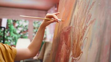 Talented artist painting an artwork with colorful paints mixed on a palette, creating a beautiful creative paintwork with a painting technique in her atelier. Painter mixing watercolor. Camera B. video