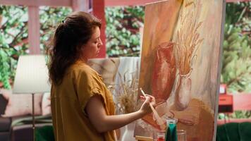 Artist uses talent and tie dye to create a masterpiece on canvas in creative workshop, blending colors with paintbrush. Bringing a rustic artwork to life with a special painting technique. Camera A. video