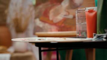 Painting inspiration supplies placed ready to be painted on canvas, watercolor painting technique in modern fine art workshop. Empty creative atelier used in creating innovative artworks. Close up. video