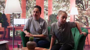 Young girl dealing with derealization and dissociation from reality, mother bringing her to counseling. Adolescent zoned out and struggling to focus during therapy session. Loss of contact. Camera A. video
