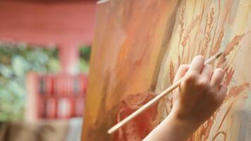 Artisan inspired by natural rural elements to paint a masterpiece on canvas, using modern paintbrushes in art studio. Working with motivation and creativity for fine art creative process. Camera A. video
