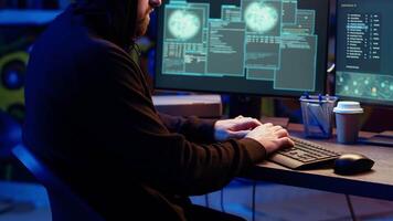 Hacker hiding in underground bunker excited after developing zero day exploit undetectable by antivirus. Malicious man successfully tricks firewalls, celebrating accomplishment, camera B close up video
