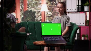 Therapist uses green screen display in a counseling session with an adolescent dealing with low confidence. Psychotherapist supports her in building resilience and self esteem. Camera A. video