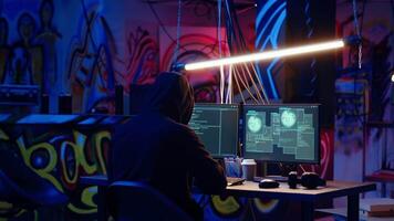 Revealing shot of spy using VPN and darknet as anonymity tools to mask online identity while stealing governmental secrets. Man in underground bunker masks his location, committing espionage, camera B video