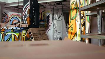 Empty building with destroyed items and graffiti paint, concept of subversive lifestyle. Criminal hideout used by teenagers to hangout and commit illegal drawing on walls video