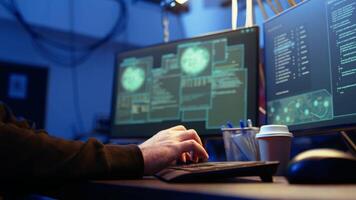 Hackers typing fast on keyboard in graffiti painted hideout, rushing to finish developing spyware software, using it to gather data from users computers without their knowledge, camera A close up video