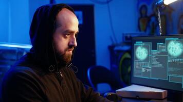 Hacker hiding in underground bunker excited after developing zero day exploit undetectable by antivirus. Malicious man successfully tricks firewalls, celebrating accomplishment, camera A close up video
