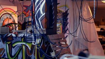 Close up of pizza boxes leftover by teenagers using abandoned building with graffiti drawings to hang out. Desolate defaced location left in messy state by edgy teens, concept of urban culture video