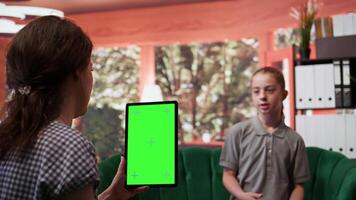Adolescent in therapy session focused on mental health next to isolated mockup screen, works on emotional well being. Psychotherapist supporting the teen to manage anxiety and depression. Camera B. video