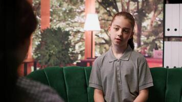 Troubled teen with internal frustrations attends a therapy session, dealing with social issues and emotional struggles. Psychotherapist provides support for mental health and resilience. Camera A. video