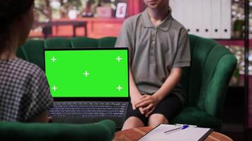 Therapist uses green screen display in a counseling session with an adolescent dealing with low confidence. Psychotherapist supports her in building resilience and self esteem. Camera A. video
