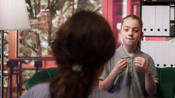 Troubled teen expressing anxiety and mental health issues during therapy session with psychologist, low confidence and internal frustration. Scared confused girl with personal troubles. Camera A. video