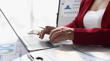 Financial plan or marketing strategy, Close up hands of accountant senior woman working on laptop and calculator with charts in office video