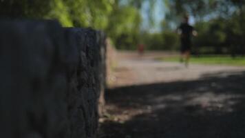 Man running in the park on a blurred background. Slow Motions. 4K video